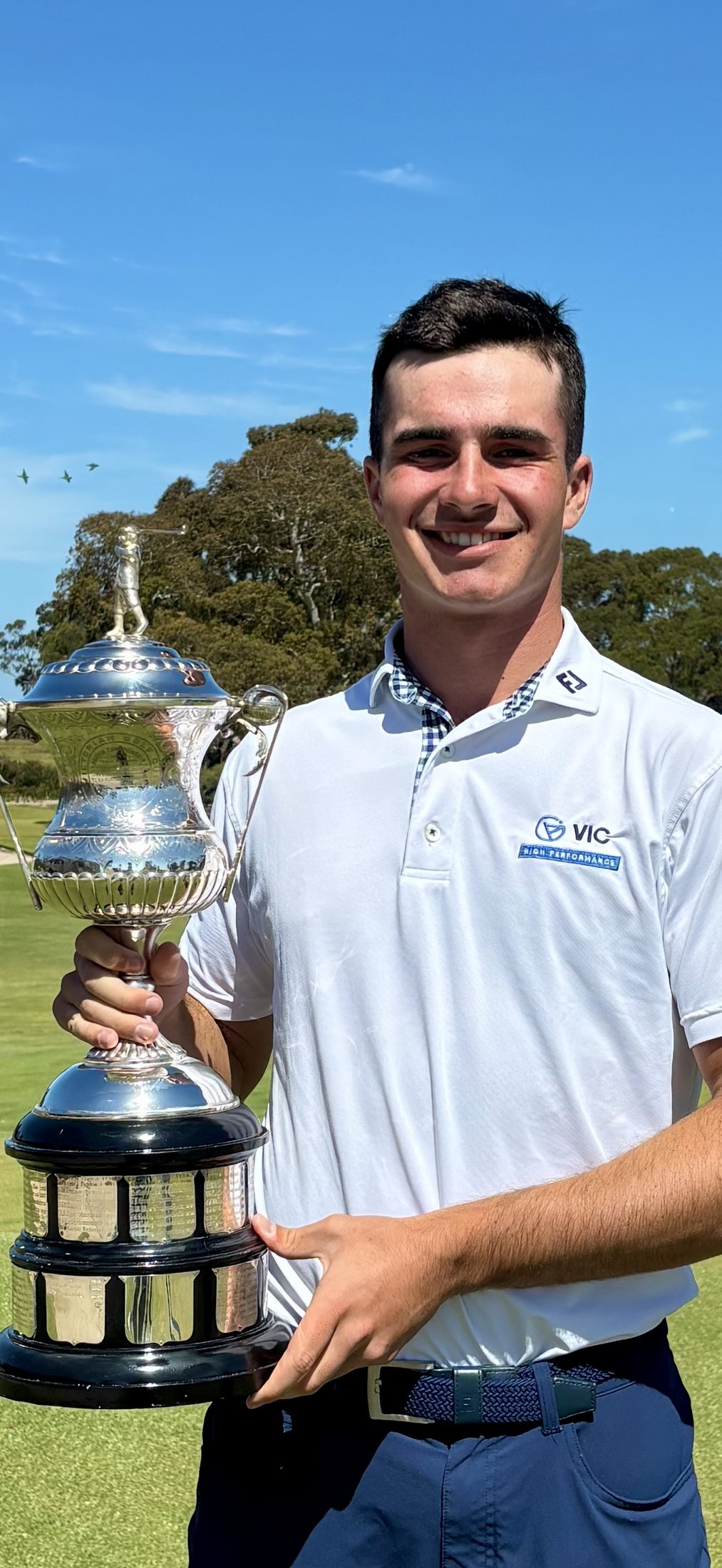 Hamish Farquharson holding a championship trophy