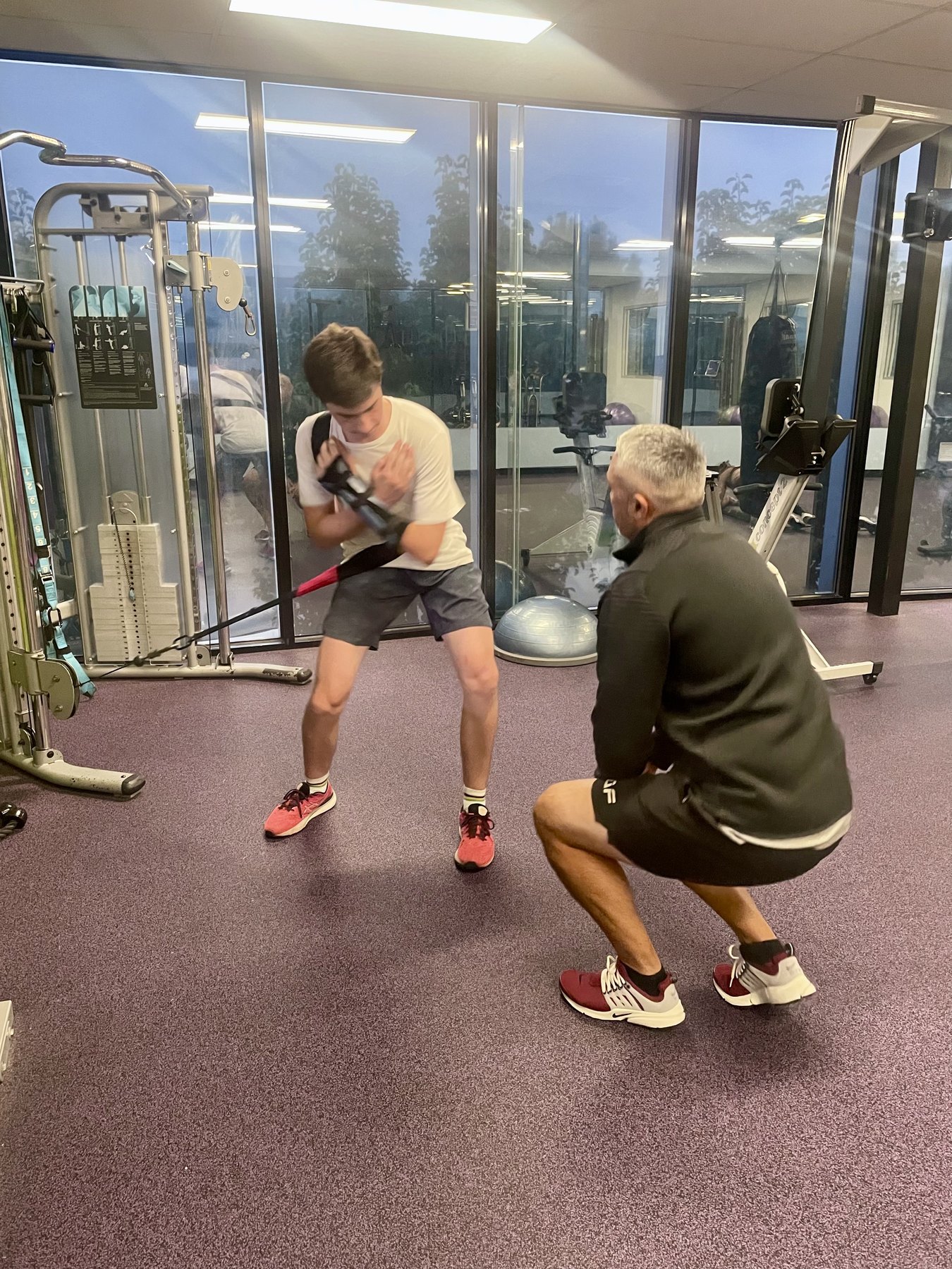 Adam coaching Hamish through adapted cable training during injury recovery